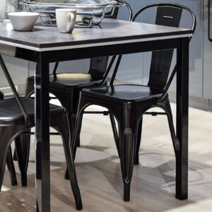 Stylish modern kitchen featuring a black metal dining table with chairs and sleek cabinetry.
